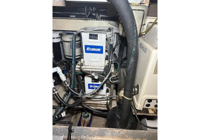 Slide: The Image of Engine room of 1989 Viking 41 Sportfish Convertible with Cruisair system and hoses. - 46