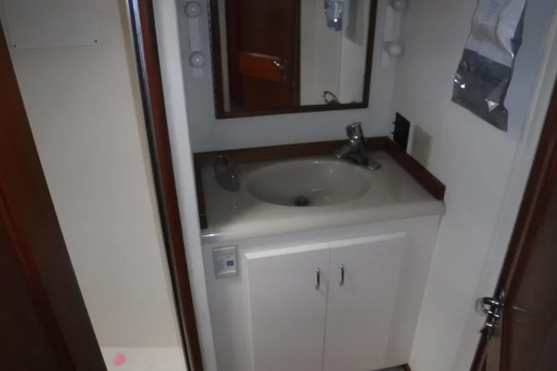 Slide: The Image of Compact bathroom sink area in a 1989 Viking 41 Sportfish Convertible yacht. - 51