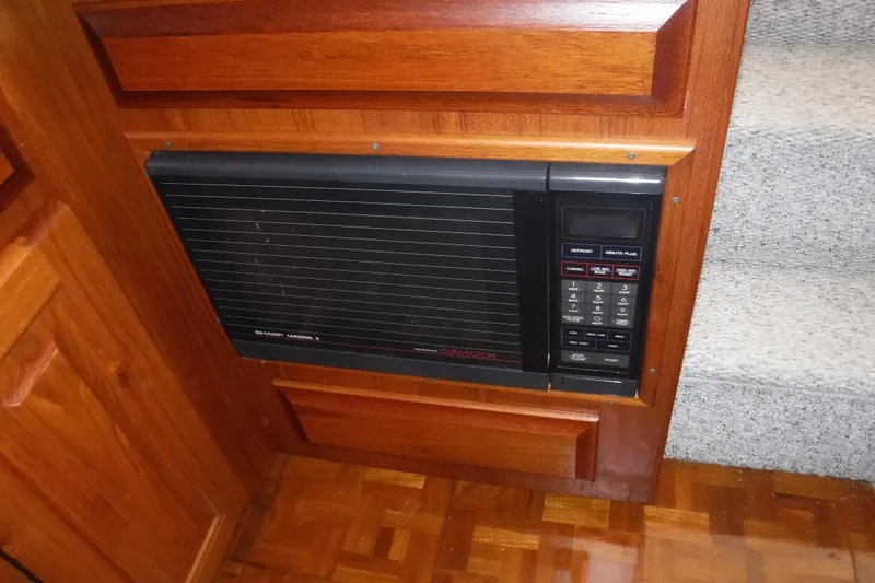 Slide: The Image of Built-in microwave on 1989 Viking 41 Sportfish Convertible yacht, wooden cabinetry. - 55