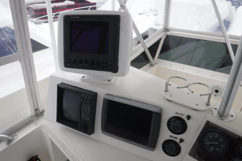 Slide: The Image of Control panel of a 1989 Viking 41 Sportfish Convertible boat with navigation equipment. - 57