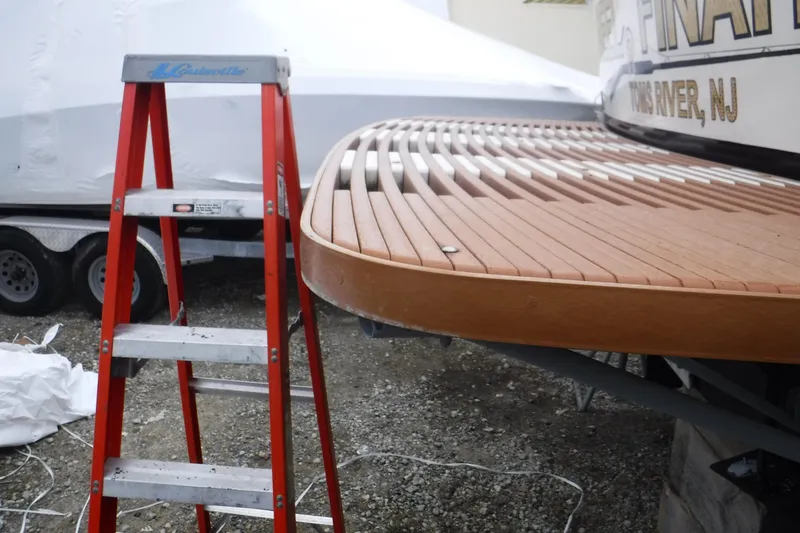 Slide: The Image of Red ladder beside 1989 Viking 41 Sportfish Convertible boat with wooden swim platform. - 58