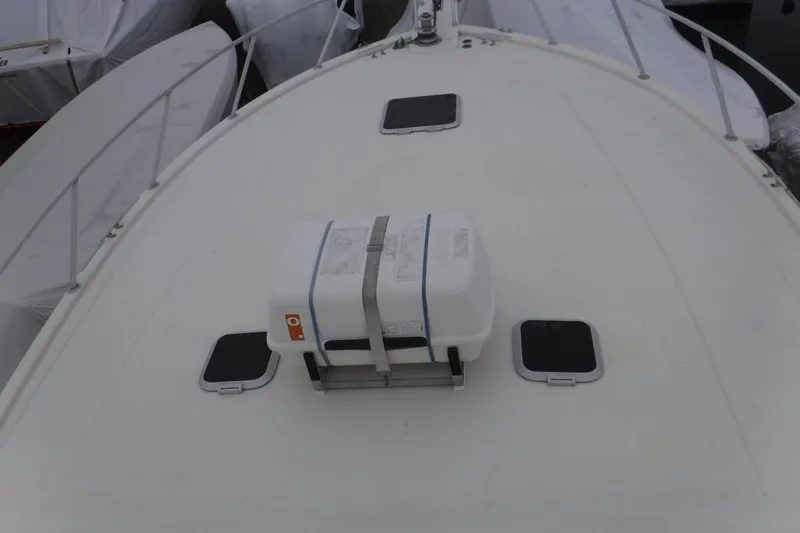 Slide: The Image of 1989 Viking 41 Sportfish Convertible boat deck with safety equipment and hatches. - 60