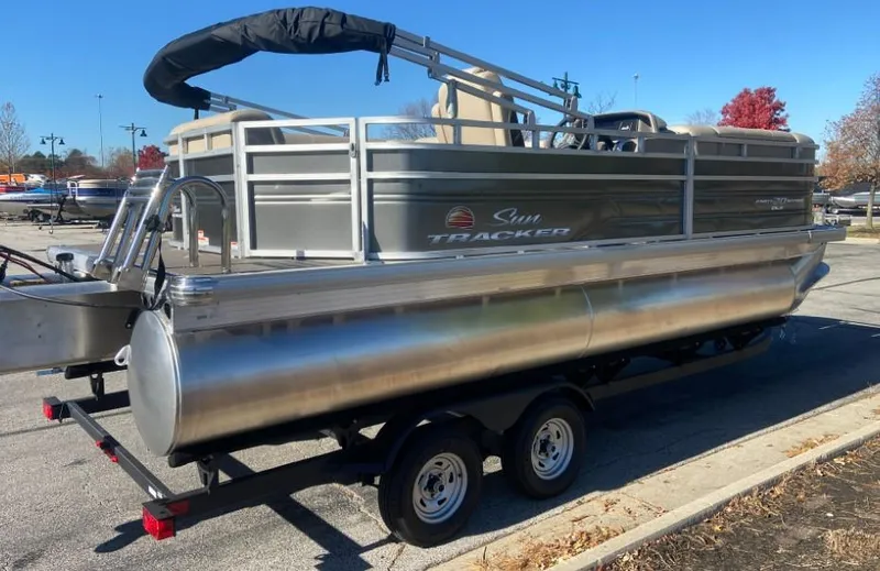 Slide: The Image of 2024 Sun Tracker Party Barge 20 DLX pontoon boat on a trailer. - 2