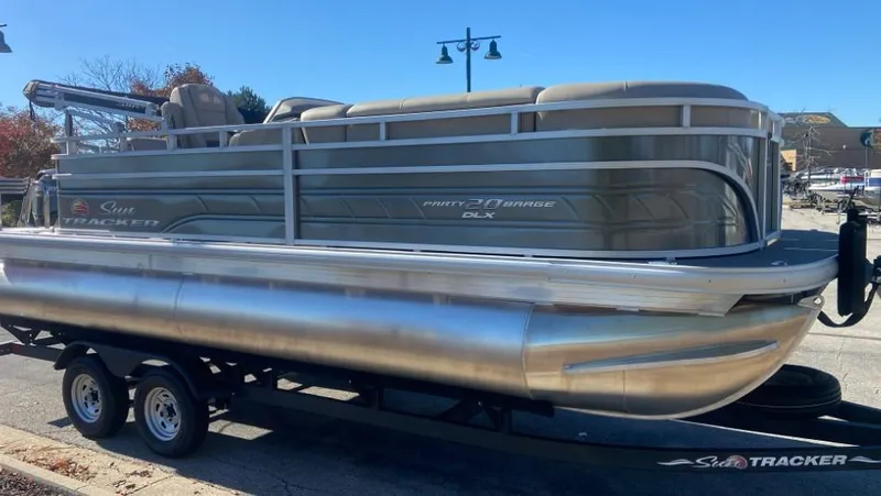 Slide: The Image of 2024 Sun Tracker Party Barge 20 DLX pontoon boat on trailer. - 3