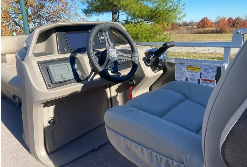 Slide: The Image of 2024 Sun Tracker Party Barge 20 DLX pontoon boat helm with steering wheel and controls. - 4