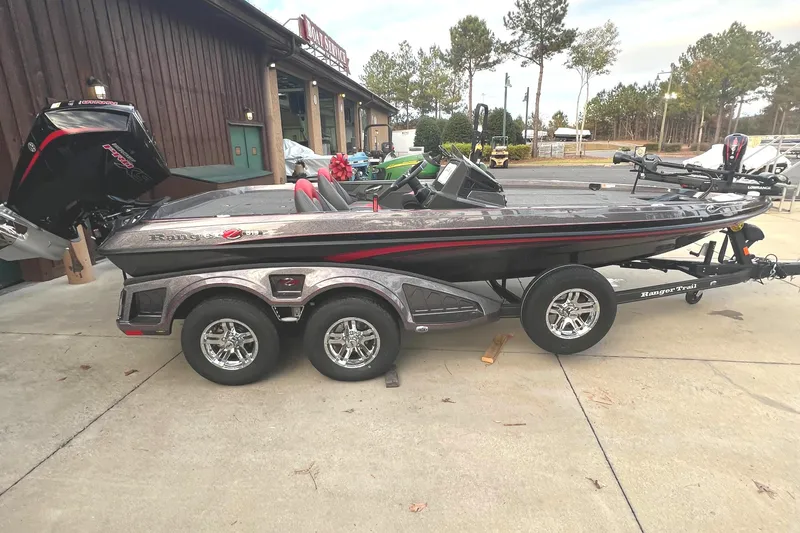 Slide: The Image of 2024 Ranger Z519 Ranger Cup Equipped boat on a trailer, parked outdoors. - 1