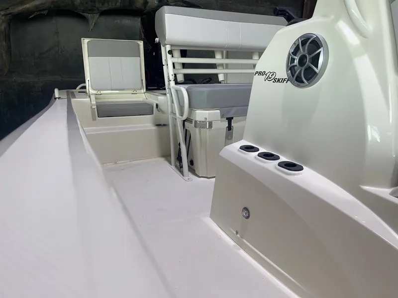 Slide: The Image of 2024 Mako Pro Skiff 19 CC interior view, featuring seating and storage compartments. - 14