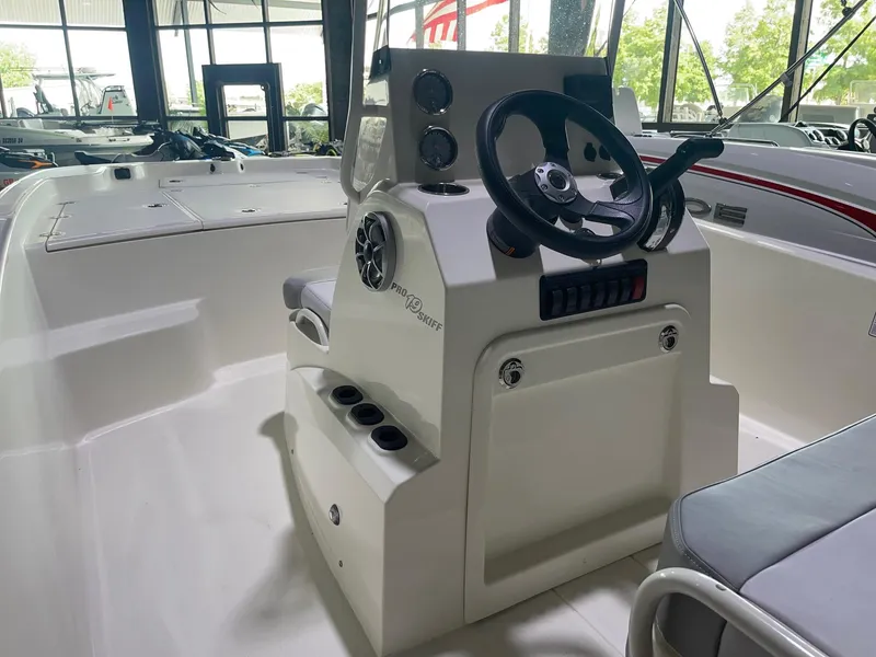 Slide: The Image of 2024 Mako Pro Skiff 19 CC center console boat interior with steering wheel. - 16