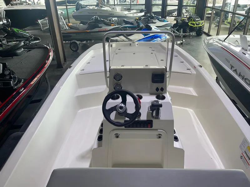 Slide: The Image of 2024 Mako Pro Skiff 19 CC center console boat in showroom. - 18