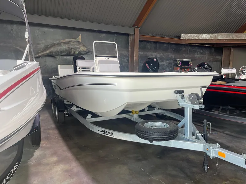 Slide: The Image of 2024 Mako Pro Skiff 19 CC boat on a trailer in a showroom. - 3