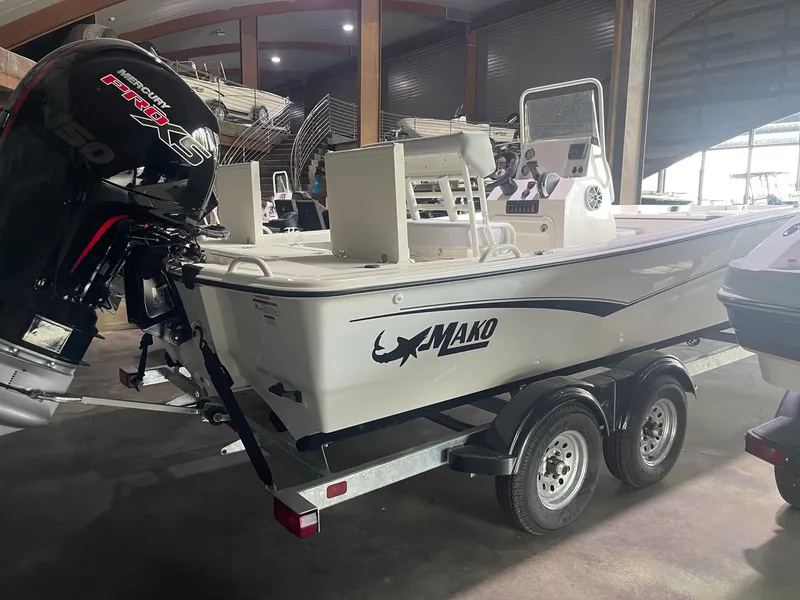 Slide: The Image of 2024 Mako Pro Skiff 19 CC boat on trailer in indoor storage. - 5