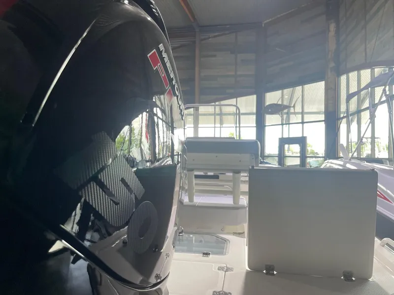 Slide: The Image of 2024 Mako Pro Skiff 19 CC boat interior with engine in showroom. - 6