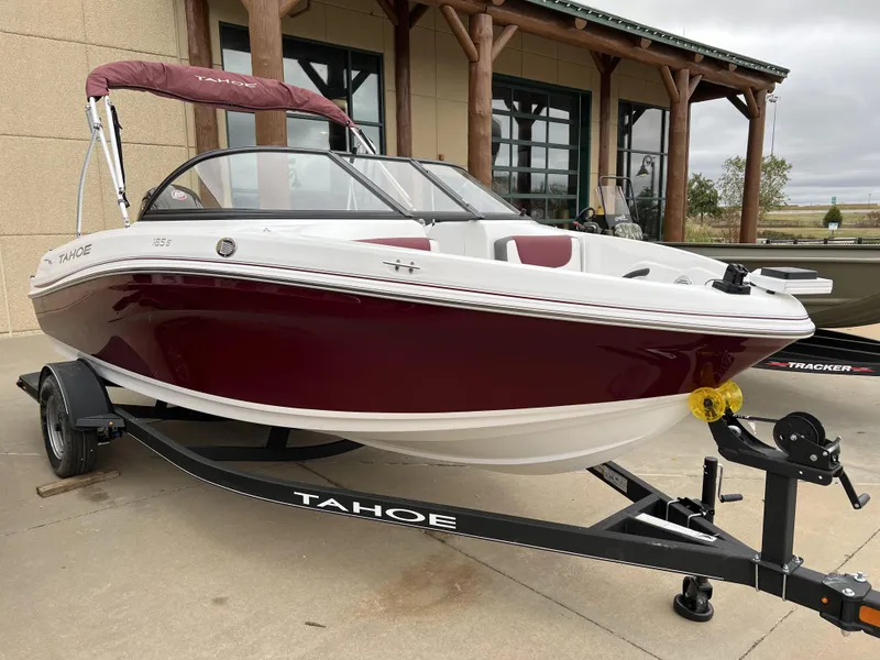 Slide: The Image of 2024 Tahoe 185 S boat with maroon and white exterior on a trailer. - 2