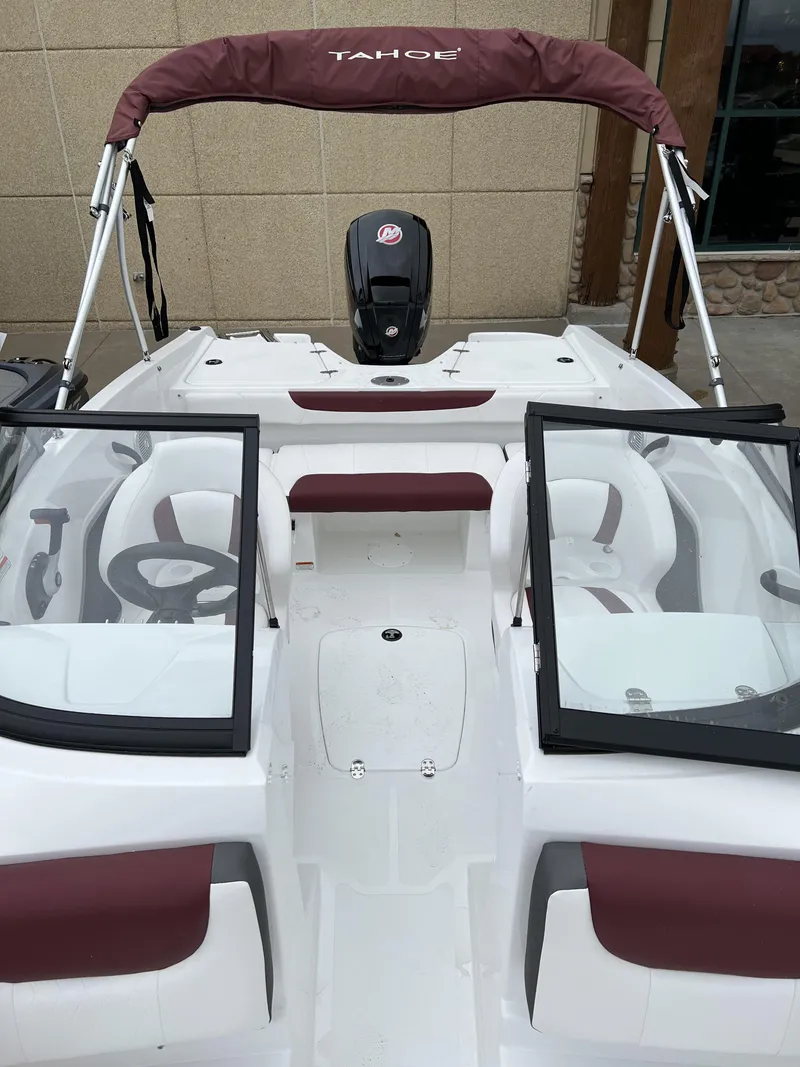 Slide: The Image of 2024 Tahoe 185 S boat with maroon and white interior, open windshield, and bimini top. - 7