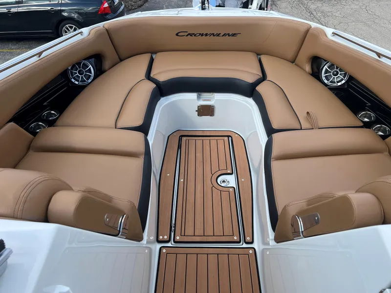 Slide: The Image of 2024 Crownline E305 boat interior with tan leather seating and teak flooring. - 3