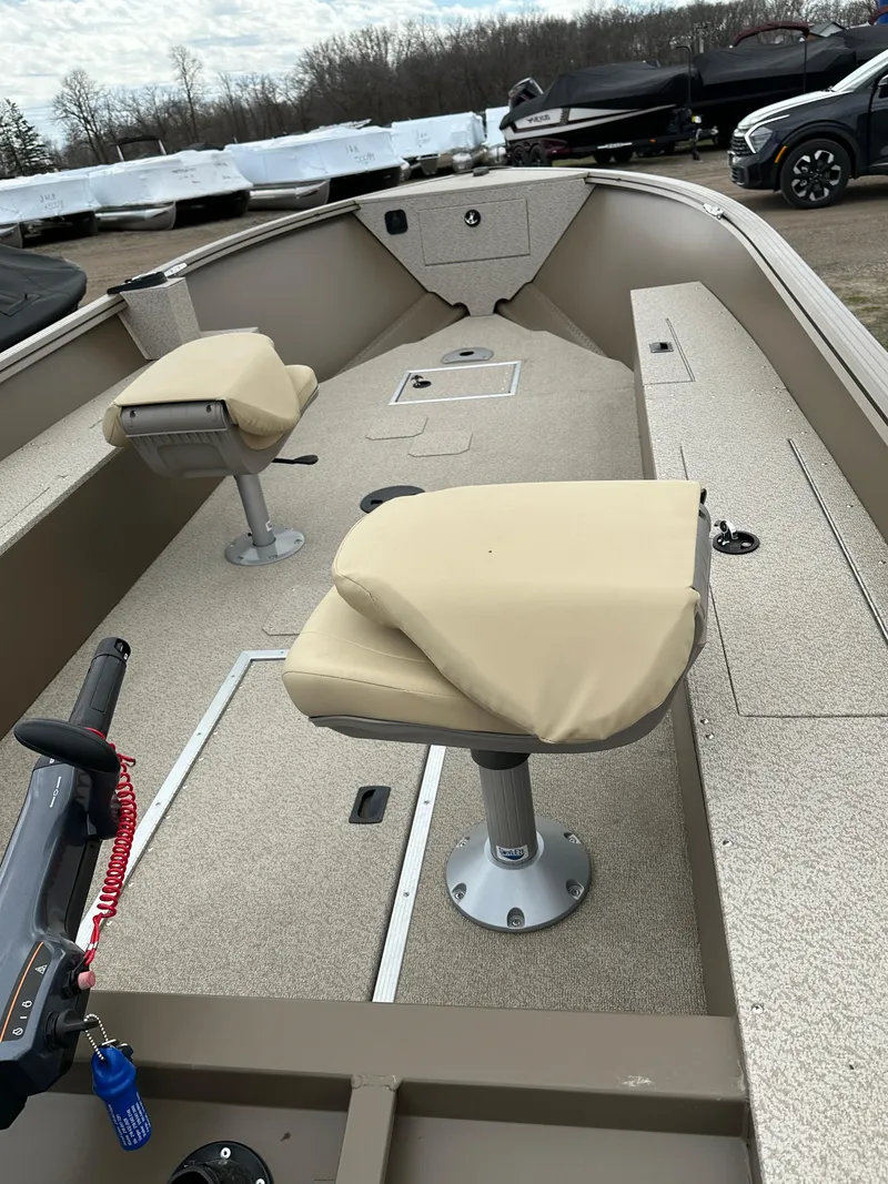 Slide: The Image of 2024 Starcraft Freedom 160TL fishing boat with beige seats and spacious deck. - 4