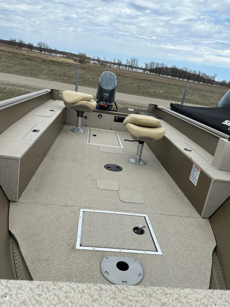 Slide: The Image of 2024 Starcraft Freedom 160TL fishing boat with beige interior and two swivel seats. - 5