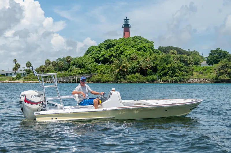 Slide: The Image of Man on 2017 Custom Envi Redfisher boat near lush island with lighthouse. - 3