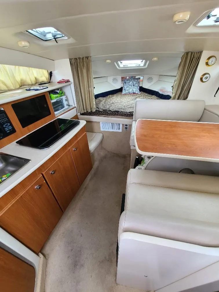 Slide: The Image of Interior of 2003 Bayliner 285 Ciera boat with kitchen, dining area, and sleeping quarters. - 15