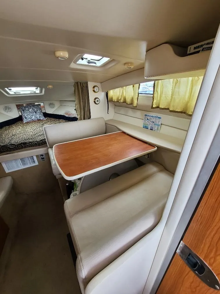 Slide: The Image of Interior of 2003 Bayliner 285 Ciera with dining area and cozy sleeping space. - 17