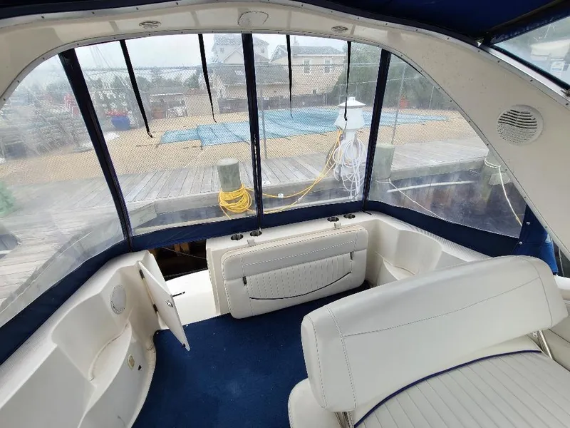 Slide: The Image of Interior view of 2003 Bayliner 285 Ciera boat with white seating and blue carpet. - 18