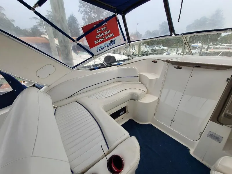 Slide: The Image of Interior of 2003 Bayliner 285 Ciera boat with white seating and blue accents. - 20