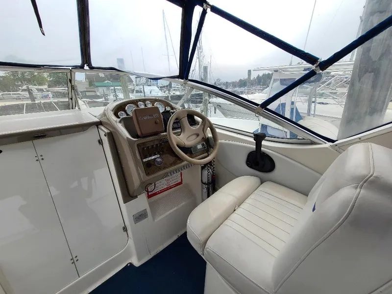 Slide: The Image of 2003 Bayliner 285 Ciera boat cockpit with steering wheel and control panel. - 21