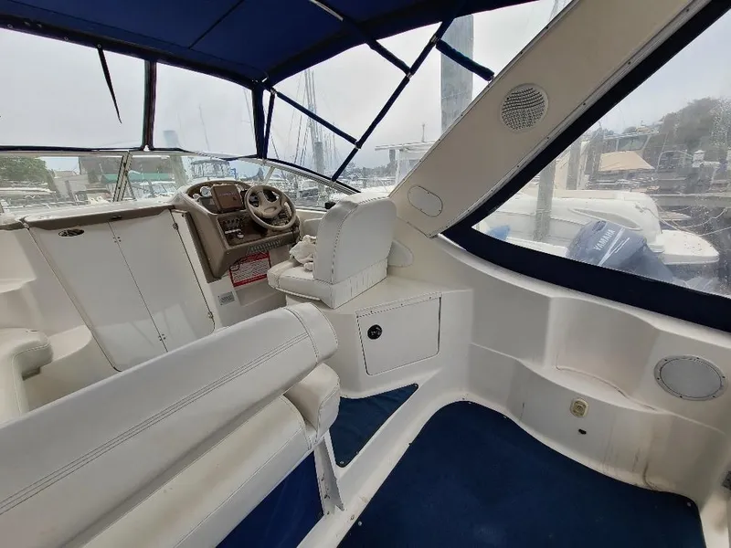 Slide: The Image of Interior of a 2003 Bayliner 285 Ciera boat with blue canopy and white seating. - 22