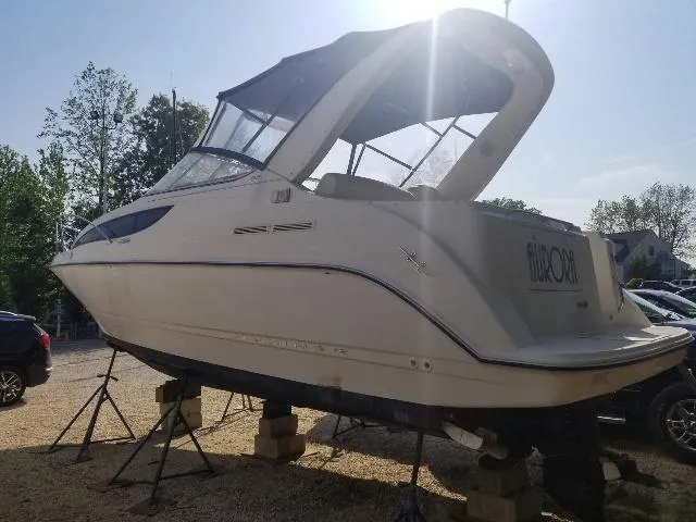 Slide: The Image of 2003 Bayliner 285 Ciera boat on stands, outdoor setting, sunny day. - 25