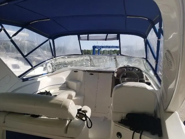 Slide: The Image of 2003 Bayliner 285 Ciera boat interior with blue canopy and white seating. - 26