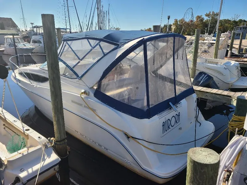 Slide: The Image of 2003 Bayliner 285 Ciera boat docked at marina with blue canopy. - 6