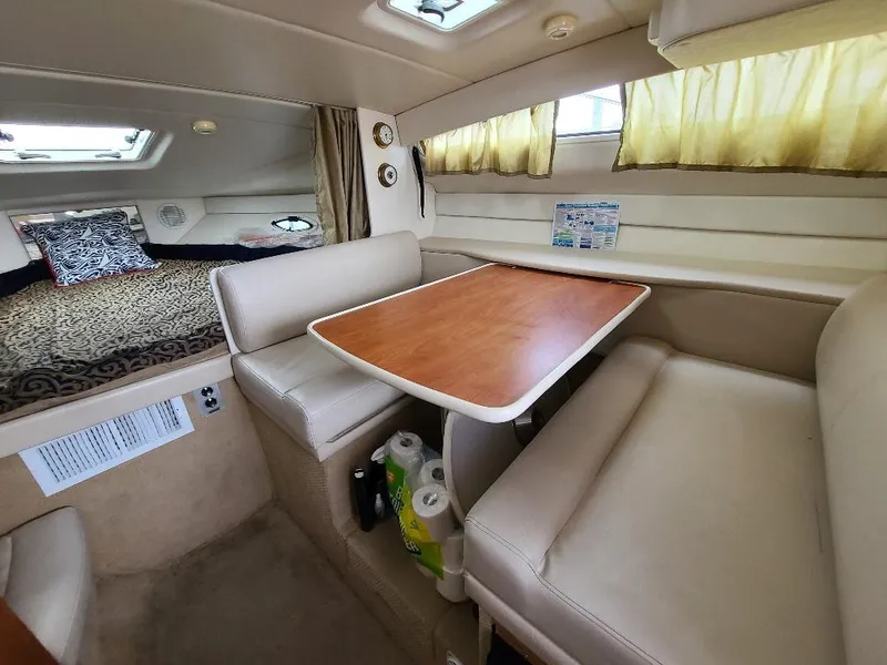 Slide: The Image of Interior of 2003 Bayliner 285 Ciera with cozy seating and sleeping area. - 9