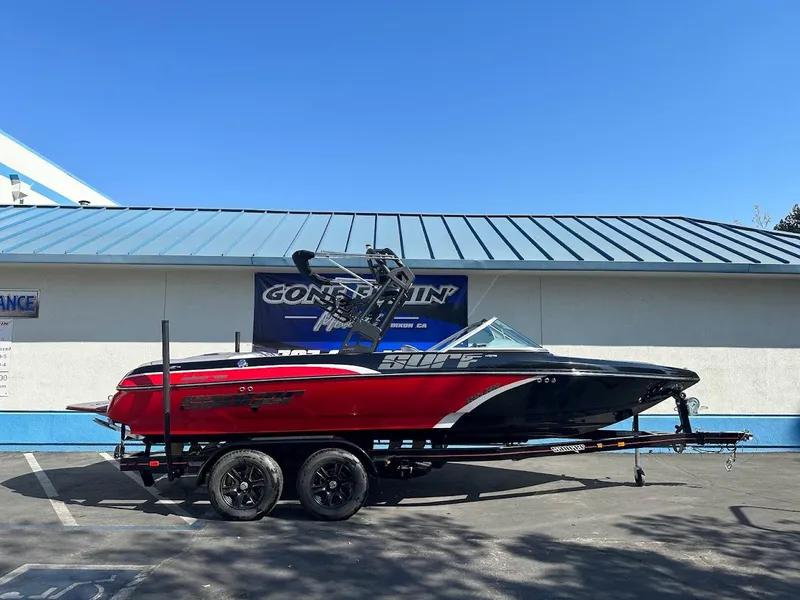 Slide: The Image of 2024 Sanger V215 SX boat in red and black on a trailer. - 1