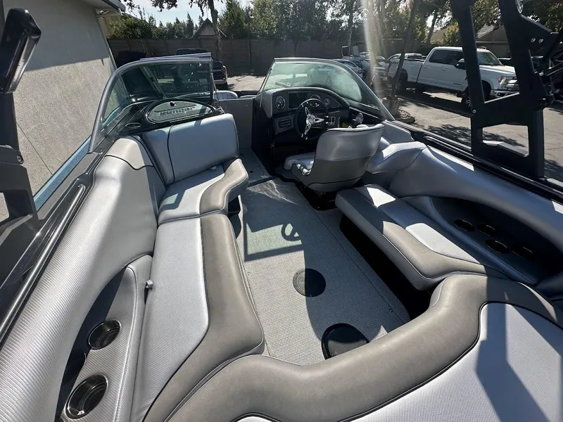 Slide: The Image of 2024 Sanger V215 SX boat interior with gray seating and modern dashboard. - 10
