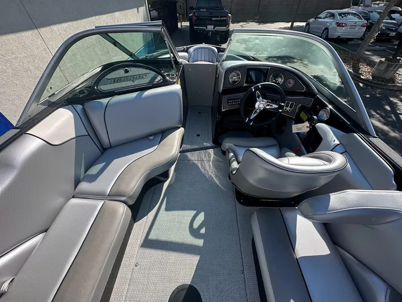 Slide: The Image of 2024 Sanger V215 SX boat interior with gray seating and modern dashboard. - 11