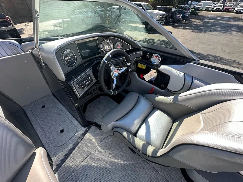 Slide: The Image of 2024 Sanger V215 SX boat interior with steering wheel and dashboard. - 12