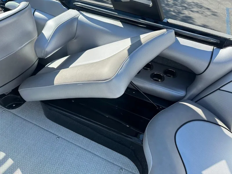 Slide: The Image of 2024 Sanger V215 SX boat interior with adjustable seating and cup holders. - 23