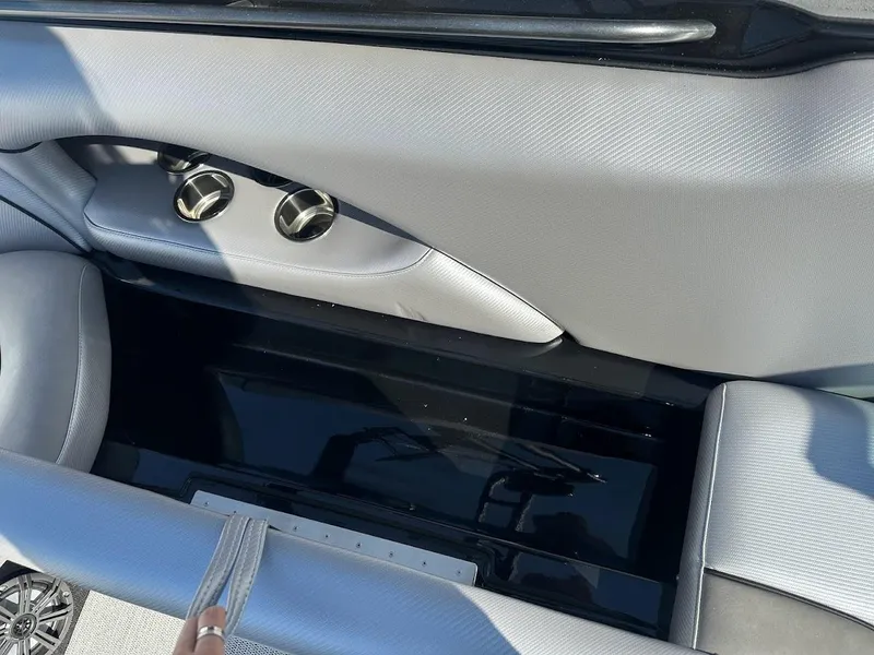 Slide: The Image of 2024 Sanger V215 SX boat interior storage compartment with silver upholstery. - 25