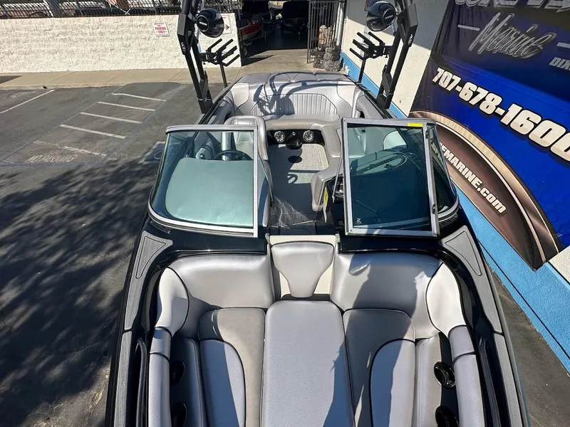Slide: The Image of 2024 Sanger V215 SX boat interior with open windshield and seating. - 28