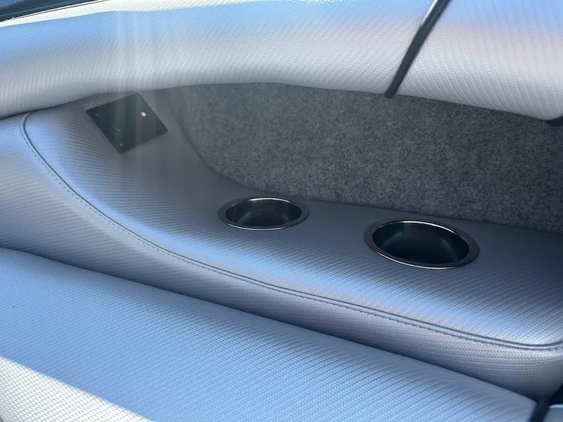 Slide: The Image of 2024 Sanger V215 SX boat interior with cup holders and grey upholstery. - 29