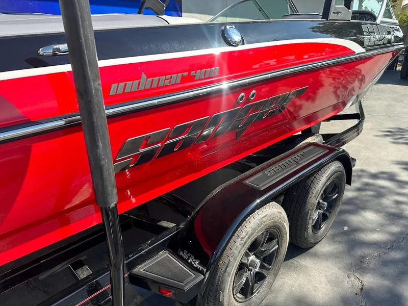 Slide: The Image of 2024 Sanger V215 SX boat in red and black on a trailer. - 36