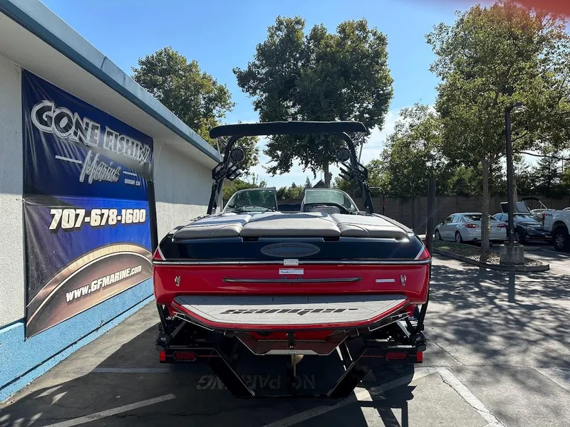 Slide: The Image of 2024 Sanger V215 SX boat displayed at dealership with banner and contact information. - 6
