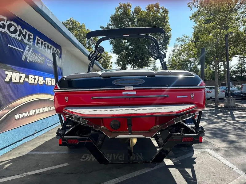 Slide: The Image of 2024 Sanger V215 SX boat, rear view, parked at GF Marine dealership. - 7