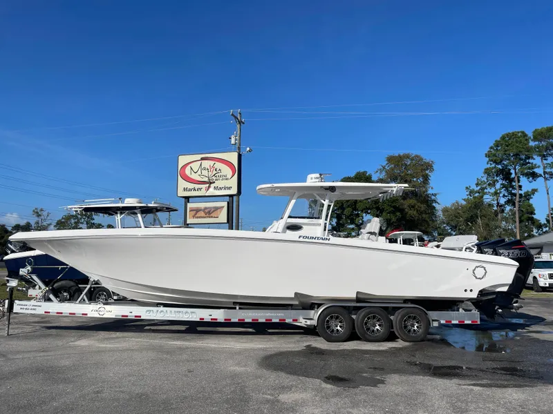 The Image of 2020 Fountain 38 Center Console boat on a trailer at a dealership. - 1