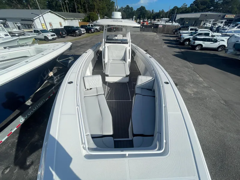 Slide: The Image of 2020 Fountain 38 Center Console boat with spacious seating, docked at a marina. - 17