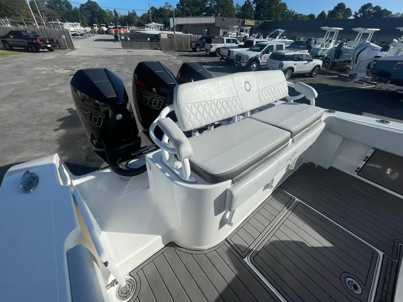 Slide: The Image of 2020 Fountain 38 Center Console boat with triple outboard engines and cushioned seating. - 7