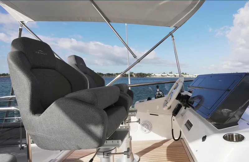Slide: The Image of 2021 Azimut S6 Sports Fly yacht helm with luxurious seating and ocean view. - 10