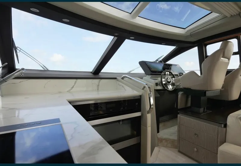 Slide: The Image of Interior of 2021 Azimut S6 Sports Fly yacht, featuring modern helm and luxurious seating. - 16