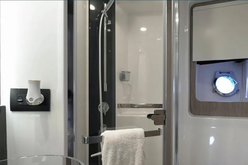 Slide: The Image of Luxurious bathroom interior of 2021 Azimut S6 Sports Fly yacht with modern shower and porthole. - 21