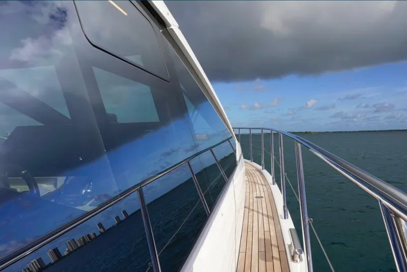 Slide: The Image of Azimut S6 Sports Fly 2021 yacht cruising on open water under cloudy skies. - 5